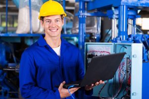 portrait of male engineer with laptop computer in factory